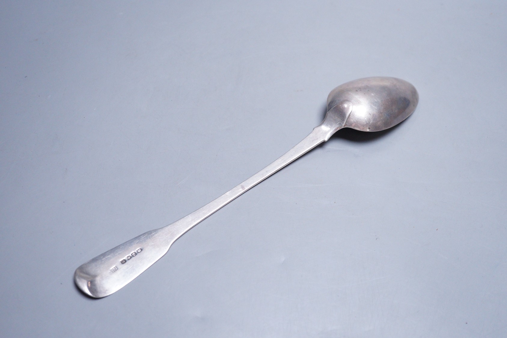 A George III silver fiddle pattern basting spoon, by Eley, Fearn & Chawner, London, 1811, 30.3cm, 124 grams, with engraved crest.